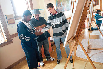 Gallup Catholic's Gary King, left, and Rehoboth Christian's Brenden Rich share their work with Artist in Residence guest artist Andrew Morrison, center, at the Gallup Cultural Center on Wednesday. © 2011 Gallup Independent / Adron Gardner 